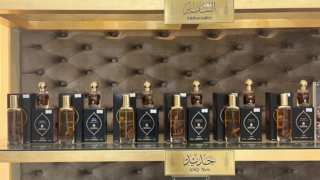 A display of various perfumes from Abdul Samad Al Qurashi, featuring elegant bottles and packaging.