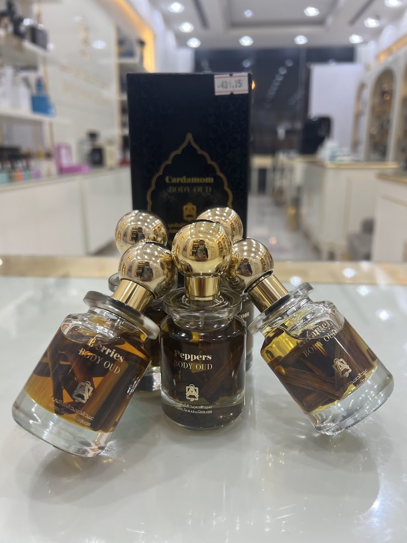 Several bottles of Abdul Samad Al Qurashi perfumes displayed with a product box.