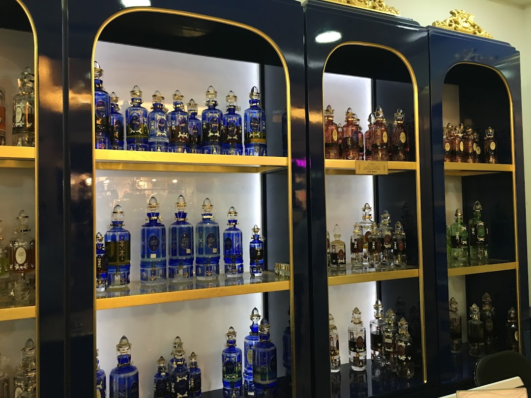 Shelves filled with ornate perfume bottles in various colors and designs.