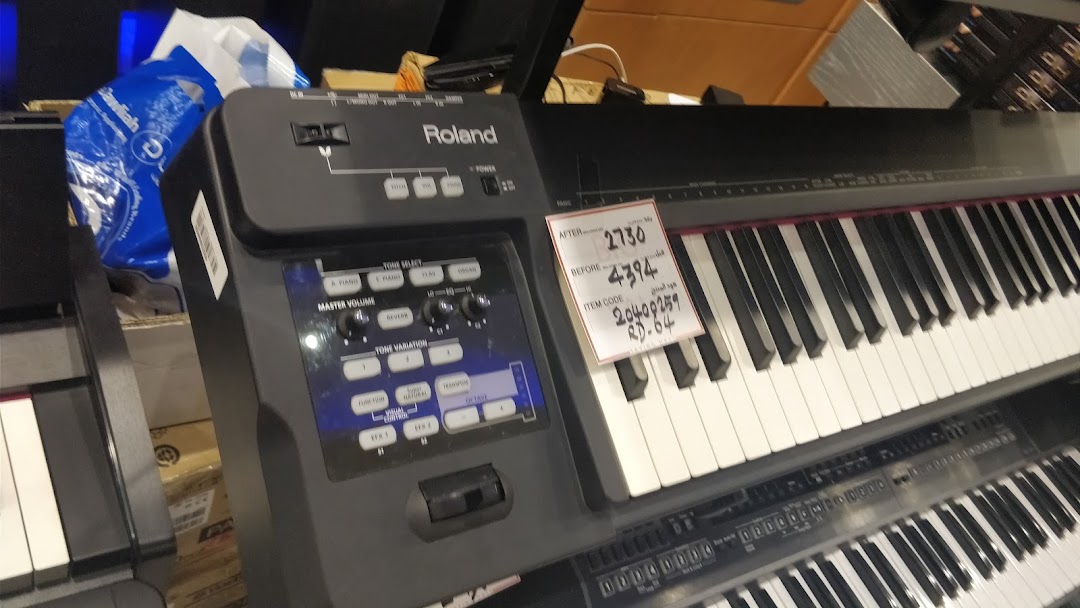 A close-up view of a Roland digital piano with a price tag showing a discount.