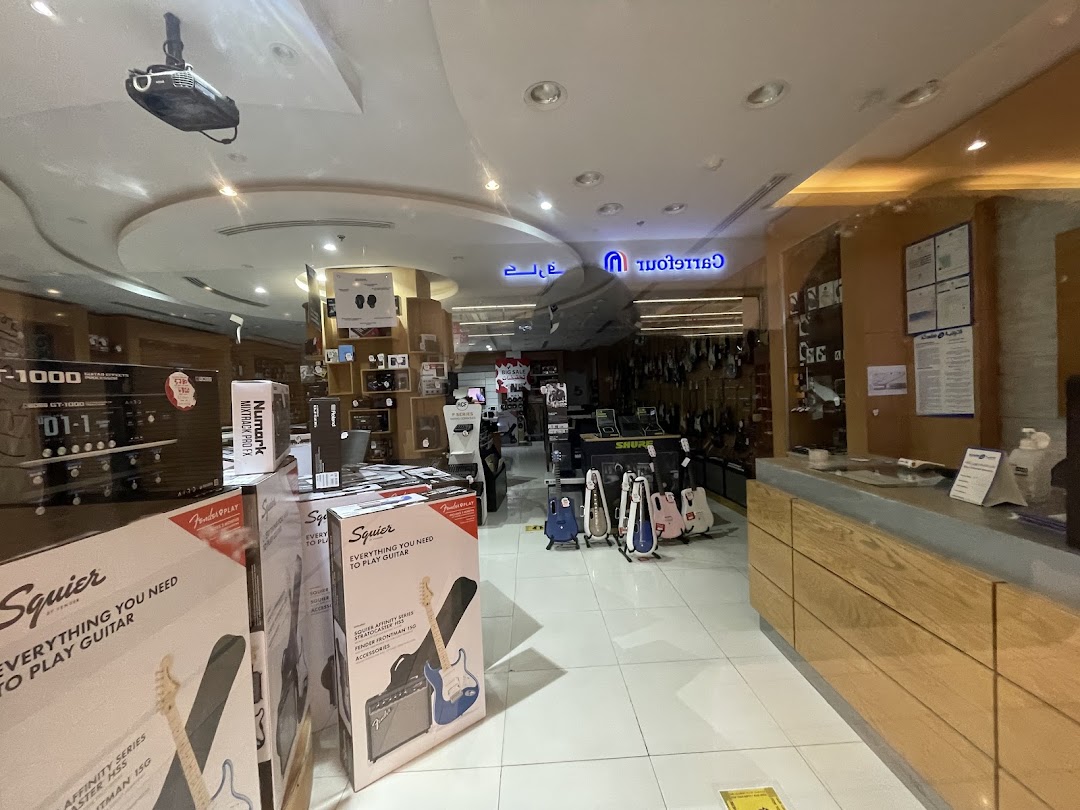 Interior view of a music store showcasing guitars, amplifiers, and music equipment.
