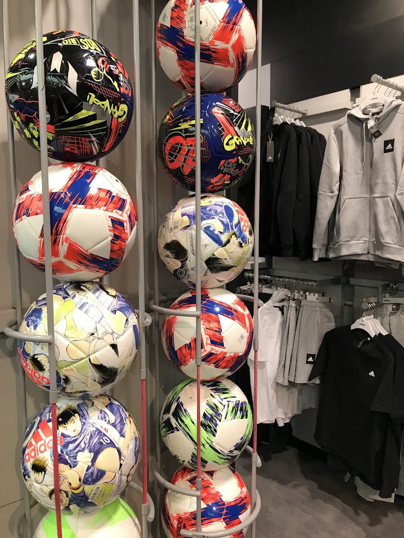 Display of Adidas soccer balls and apparel, including hoodies and t-shirts.