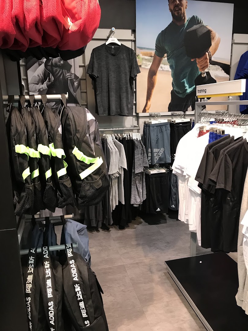 Interior view of an Adidas store showcasing athletic apparel and accessories.