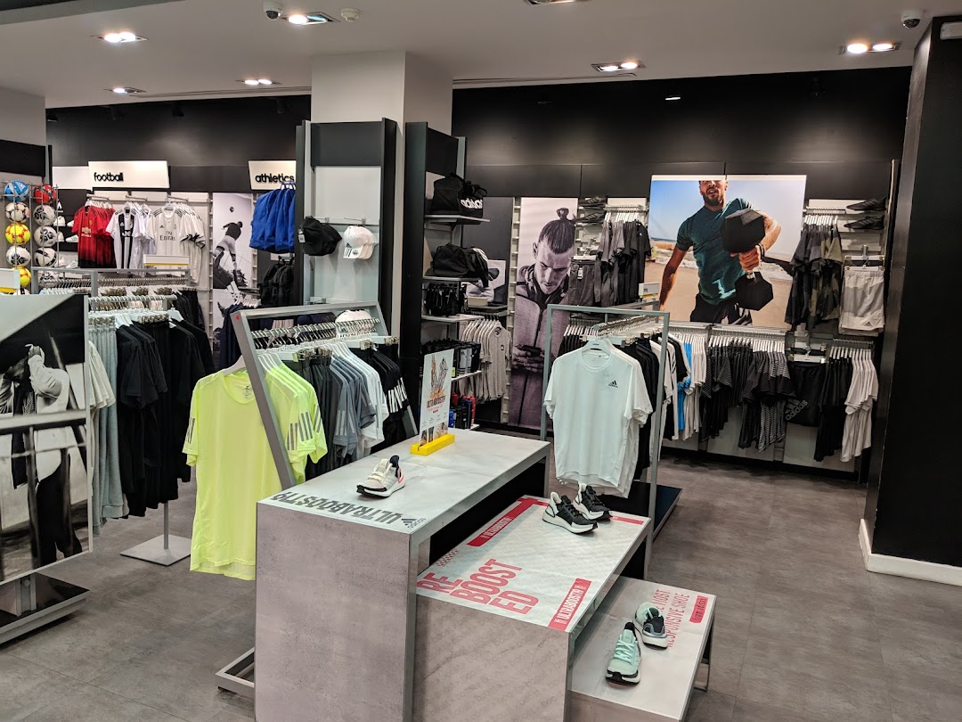 Interior view of an Adidas store showcasing athletic apparel and footwear.
