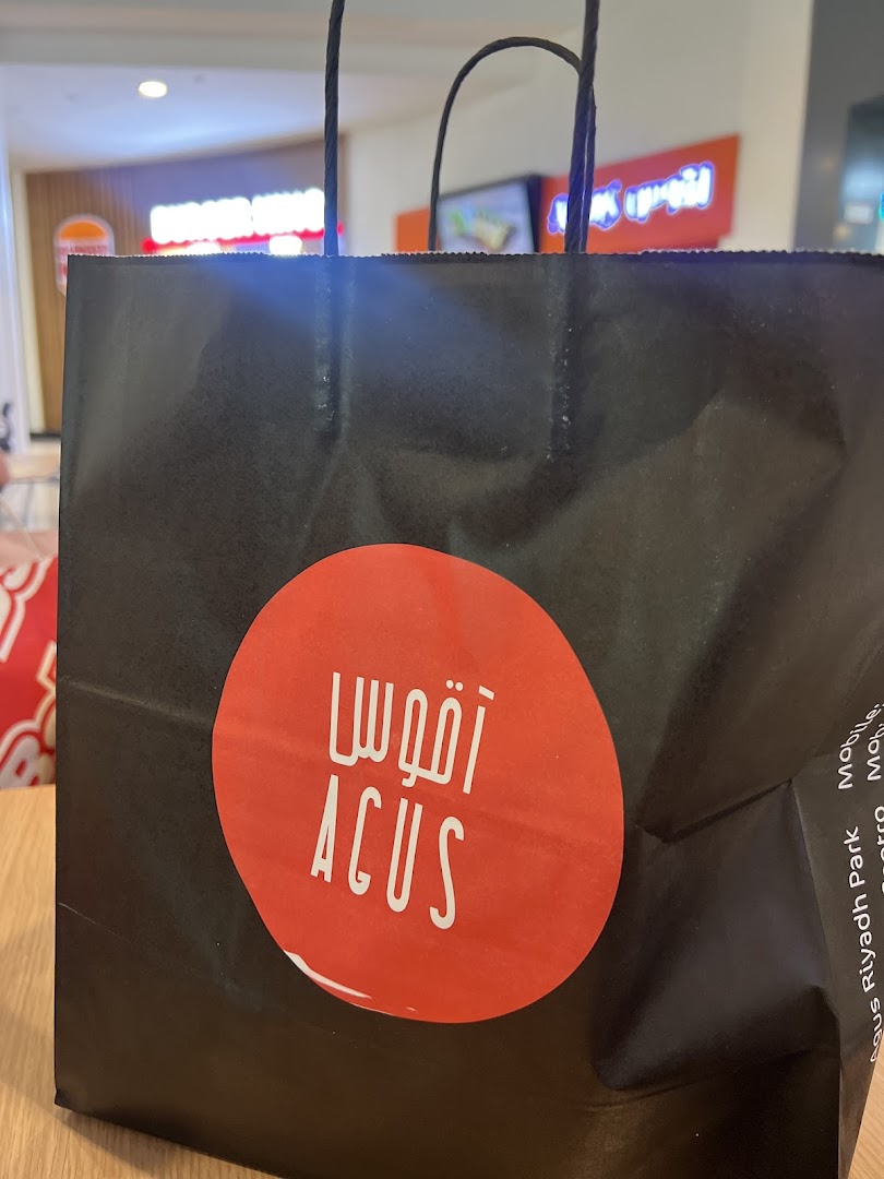 A black shopping bag with a red circular logo for Agus Restaurant.