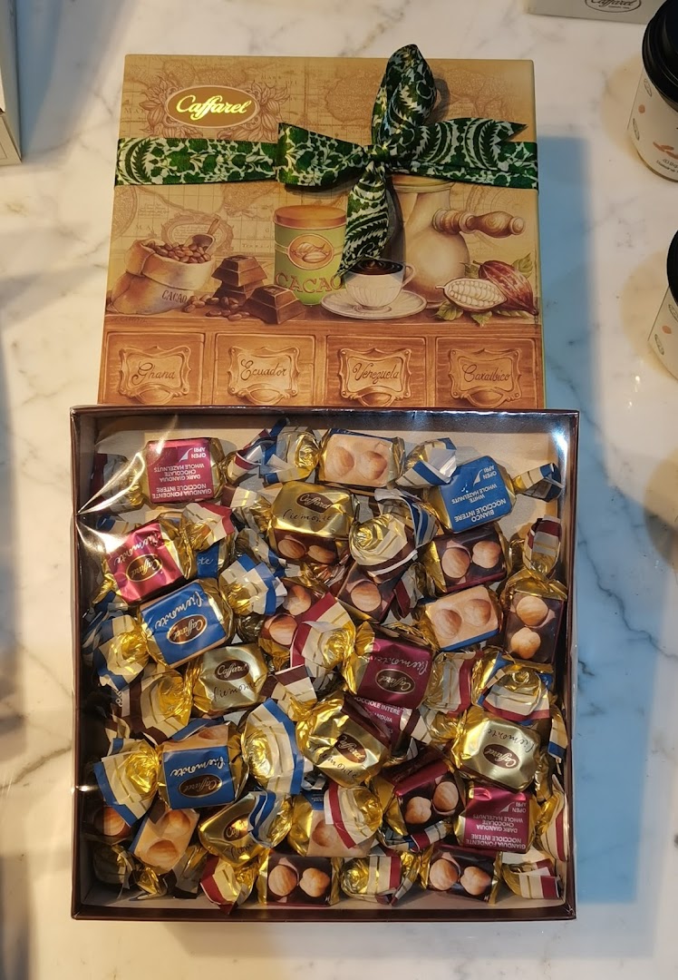 A box of assorted Caffarel chocolates, featuring a decorative lid and individually wrapped candies.