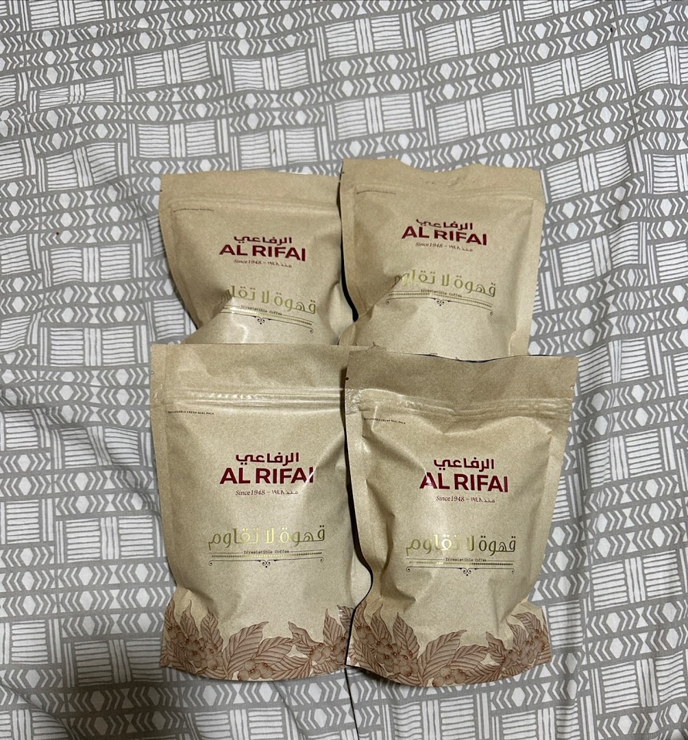 Four bags of Al Rifai coffee are displayed on a patterned surface.