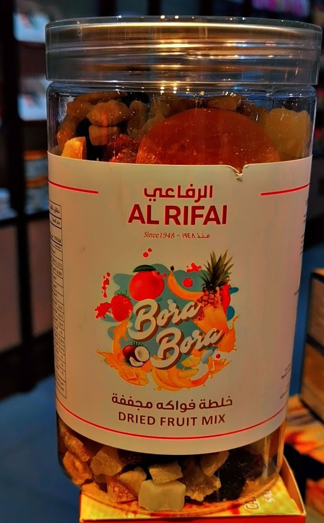A clear plastic jar filled with a variety of dried fruits, labeled "Al Rifai Roastery Bora Bora Dried Fruit Mix."