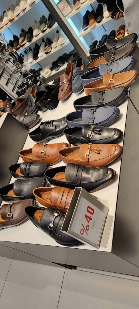 A display of various men's loafers and dress shoes in different colors and styles.