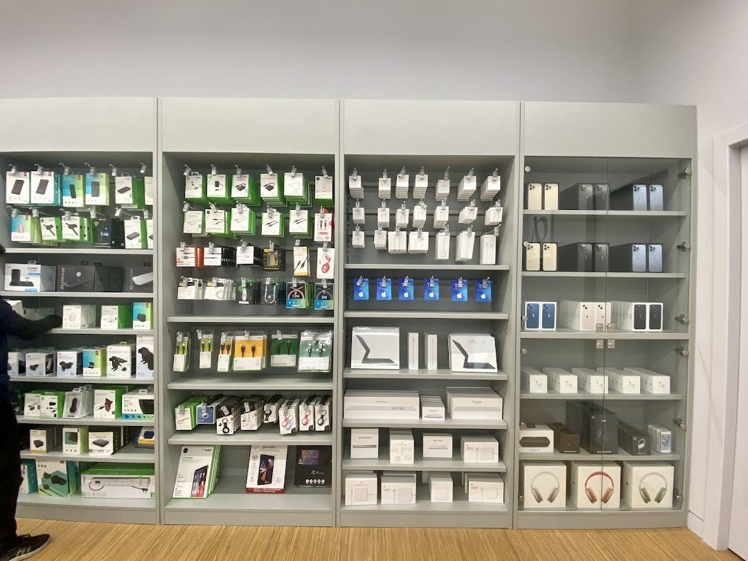 Interior view of an Apple Premium Partner store showcasing various Apple products and accessories on display shelves.