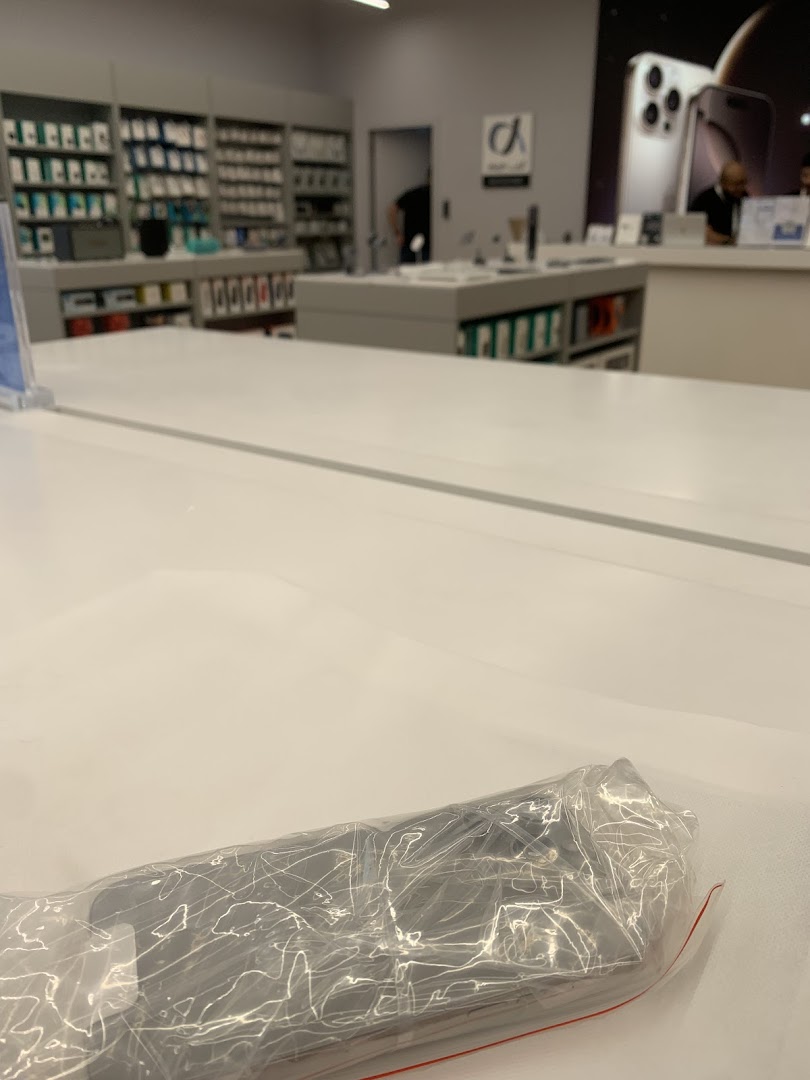 Interior view of an Apple Premium Partner store showcasing products and displays.