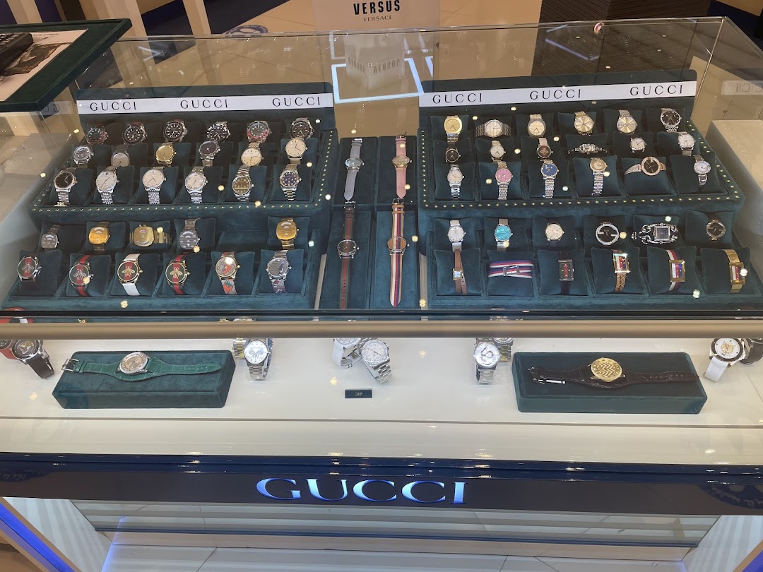 A display case filled with various Gucci watches, showcasing different styles and designs.