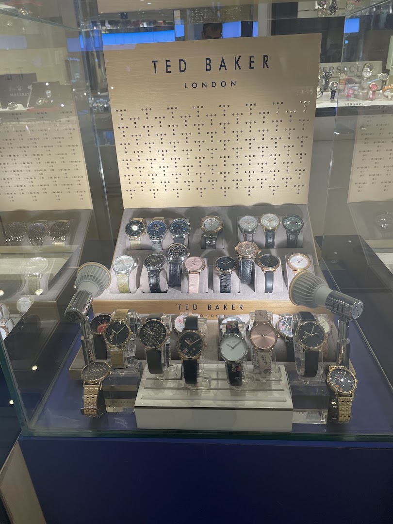 A display case filled with various Ted Baker London watches for sale.