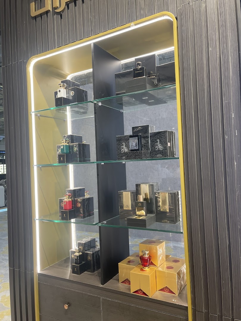 A display cabinet showcasing various perfumes and oud products from Almajed For Oud.