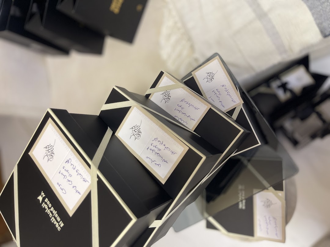Elegantly packaged oud products from Almajed For Oud, featuring handwritten notes.