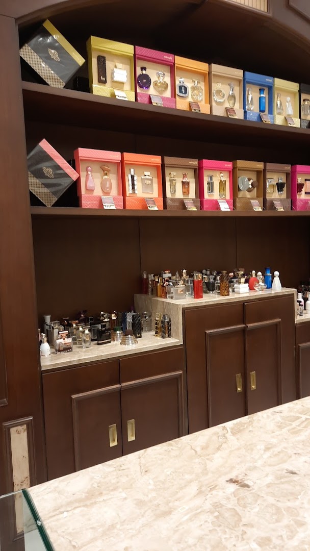 A display of various perfumes and gift sets on shelves and counters.
