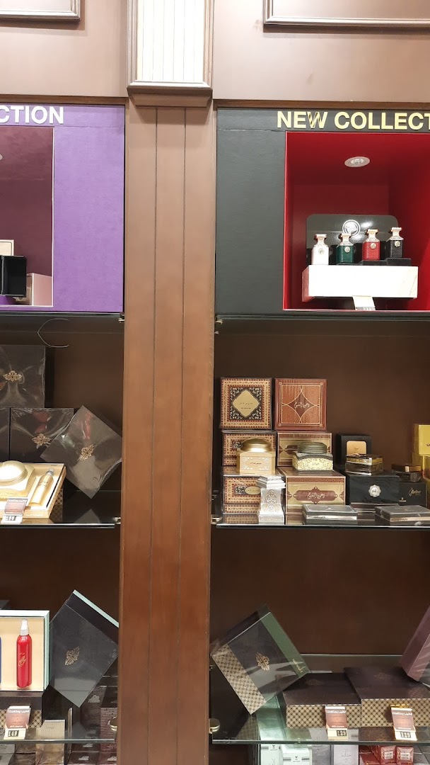 A display of elegant perfume bottles and gift boxes in a retail store.