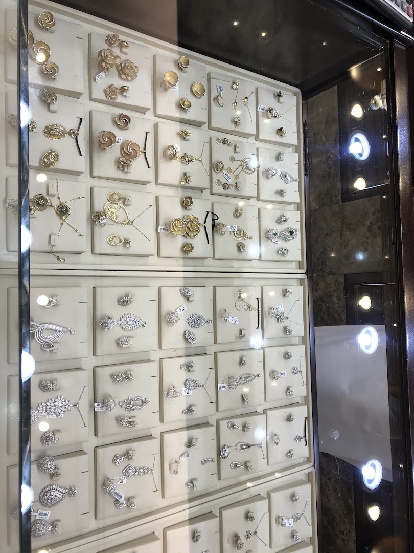 A display case filled with various gold and diamond jewelry, including necklaces, earrings, and rings.