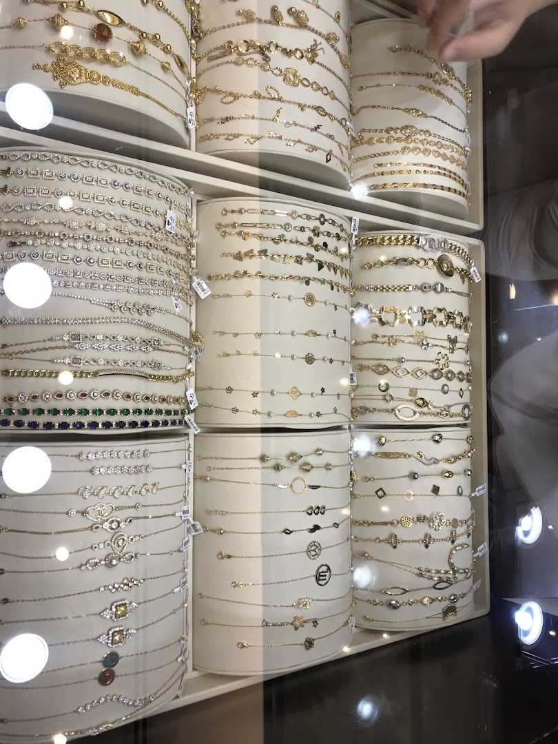 A display of various gold and diamond bracelets in a jewelry store.