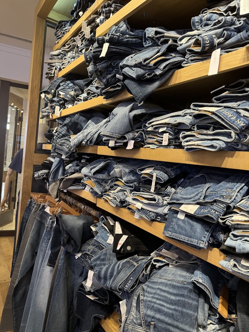 Shelves overflowing with neatly folded jeans at American Eagle.