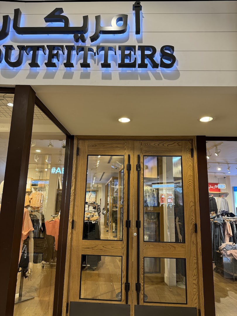 The entrance to an American Eagle Outfitters store with wooden doors and illuminated signage.