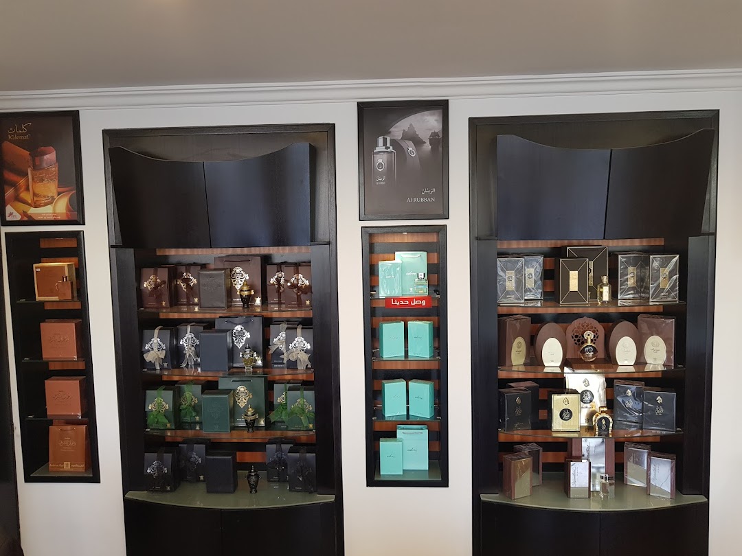 A well-lit display of various perfumes and gift sets on shelves.