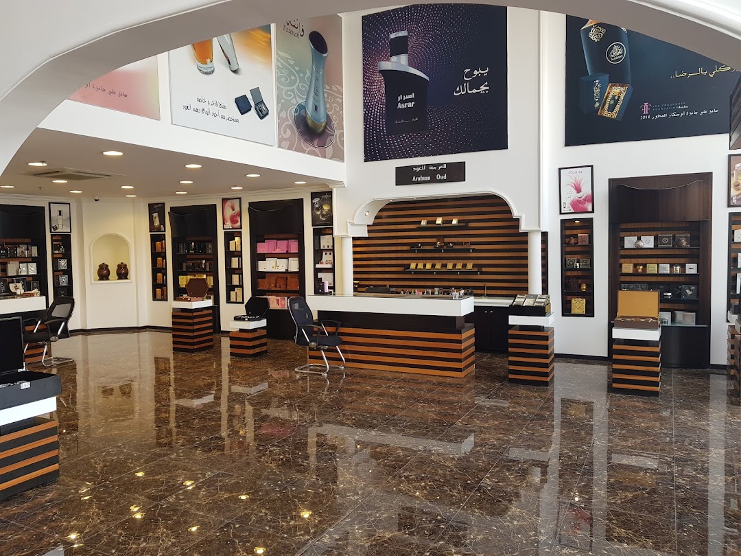 Interior view of a luxurious Arabian Oud perfume shop with display shelves and a counter.