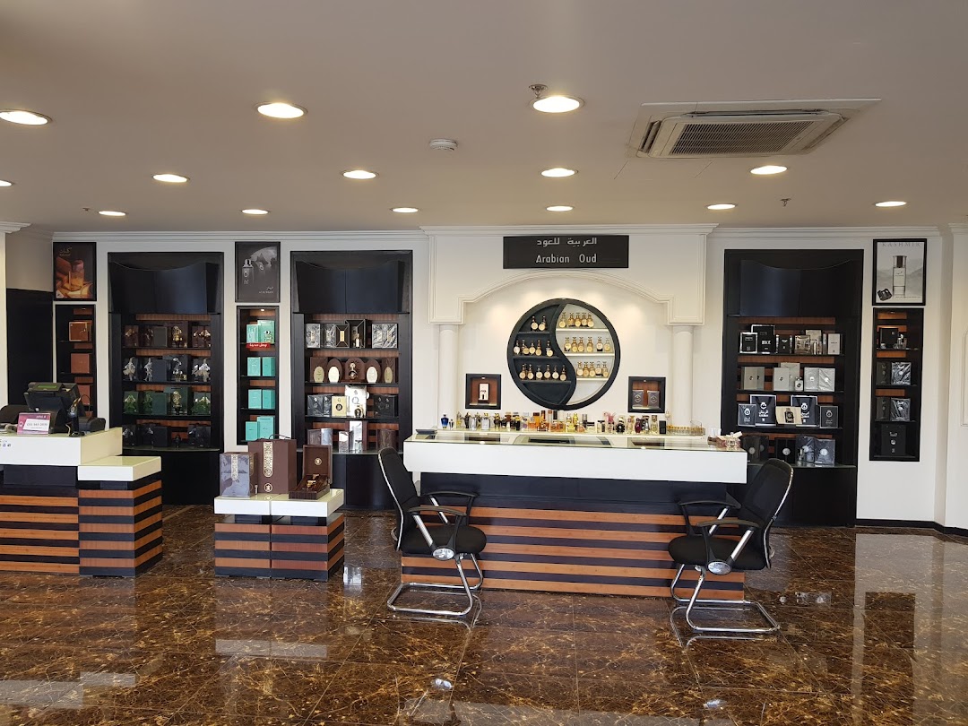 Interior view of Arabian Oud 359 perfume shop with display shelves and a counter.
