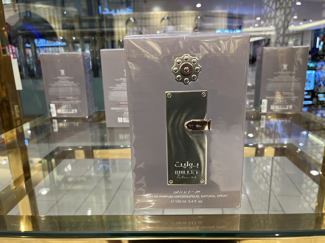 A display of Arabian Oud 'Bullet' perfume bottles in a retail store.