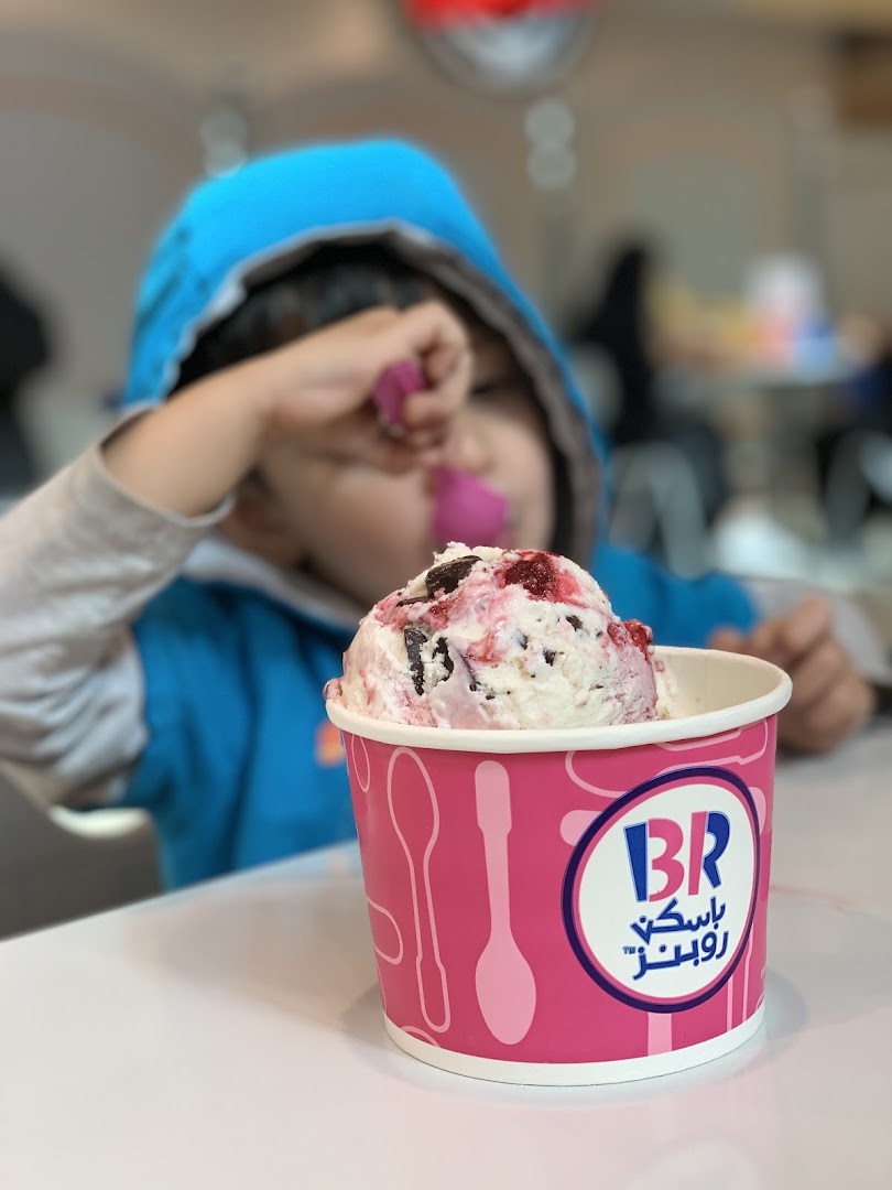 A child enjoys a cup of ice cream from Baskin Robbins.