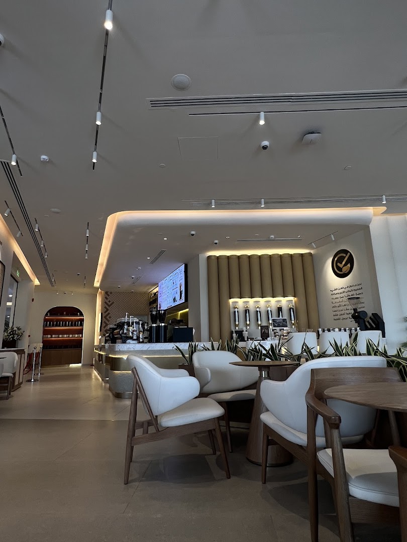 Interior view of a modern coffee shop with seating and a counter.