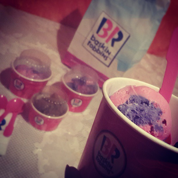 A close-up of Baskin Robbins ice cream cups and a bag.