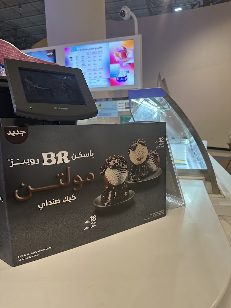 Baskin Robbins counter with a promotional display for a new ice cream cake.
