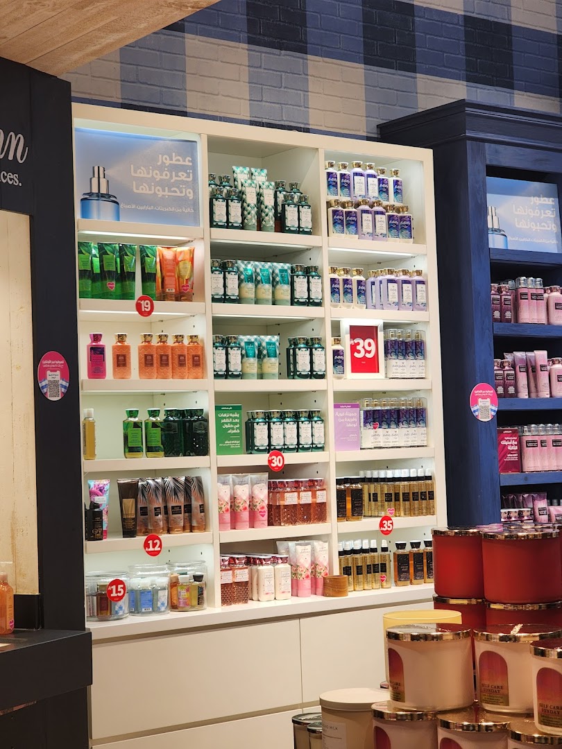 Shelves stocked with various Bath & Body Works lotions, soaps, and candles.
