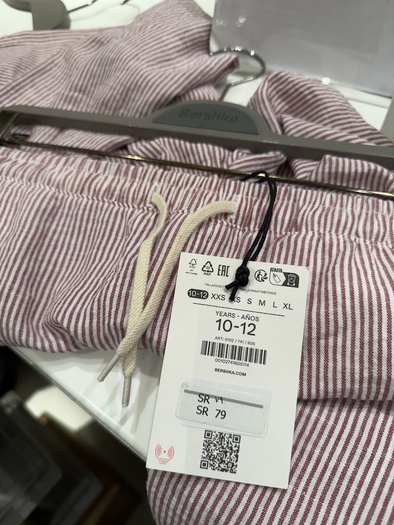 Close-up of striped clothing from Bershka with a price tag.