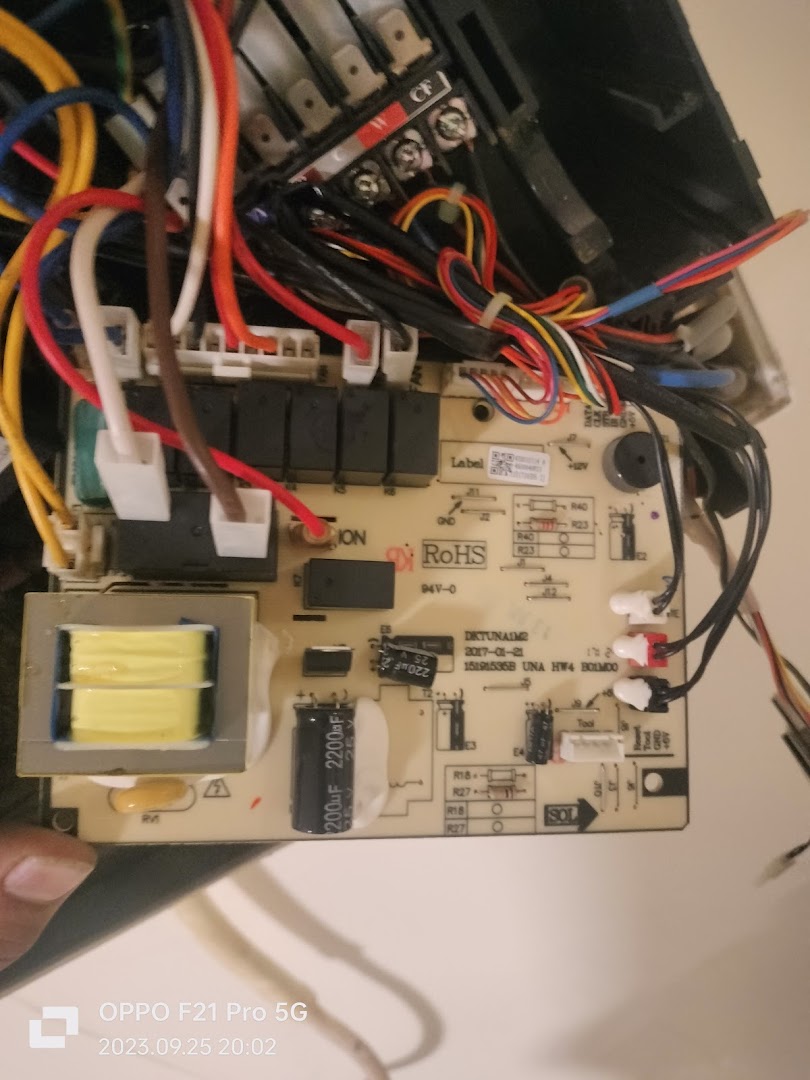 Close-up of an electronic circuit board with many wires and components.