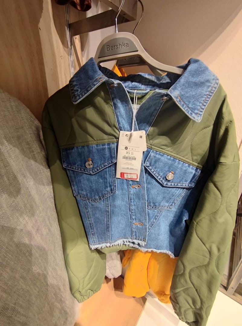 A stylish denim and green quilted jacket from Bershka with price tags.