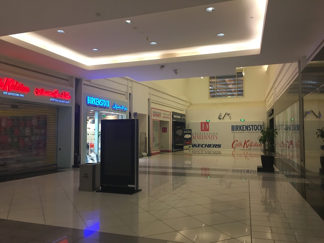 A shopping mall corridor with several store fronts including Birkenstock and Cath Kidston.