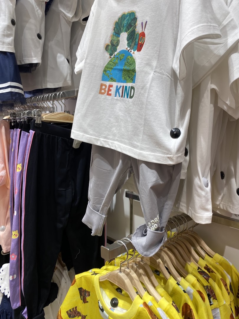 Children's clothing featuring colorful graphics and comfortable designs displayed on hangers.