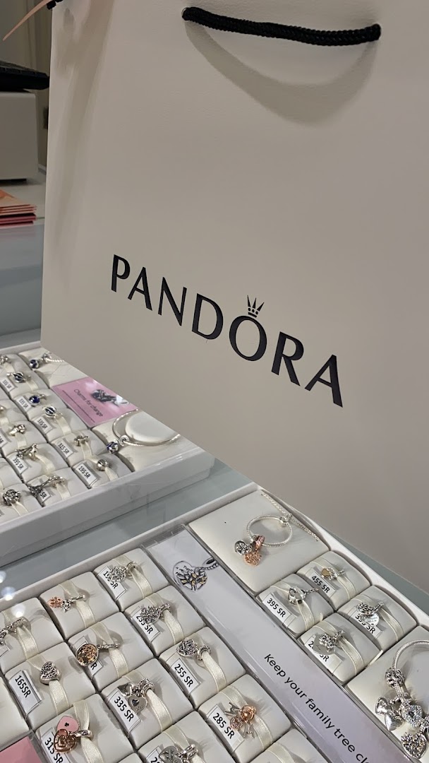 Pandora store display featuring various charms and jewelry with prices displayed.