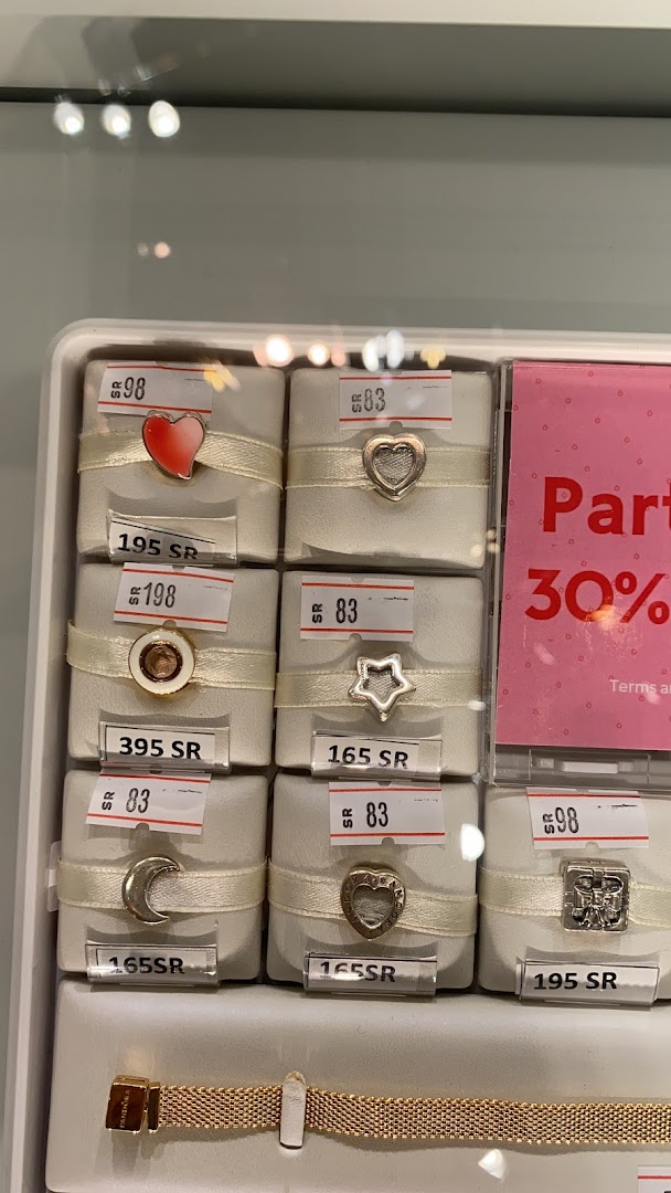 A display of Pandora charms and a bracelet with prices and a 30% off promotion.