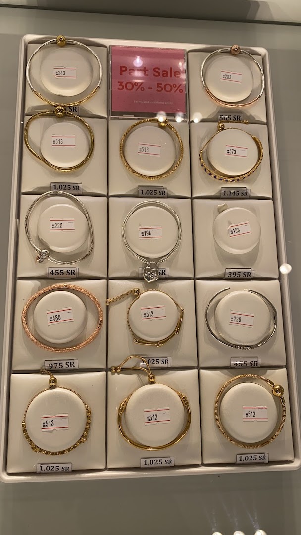A display of Pandora bracelets with prices and a 'Part Sale' sign.