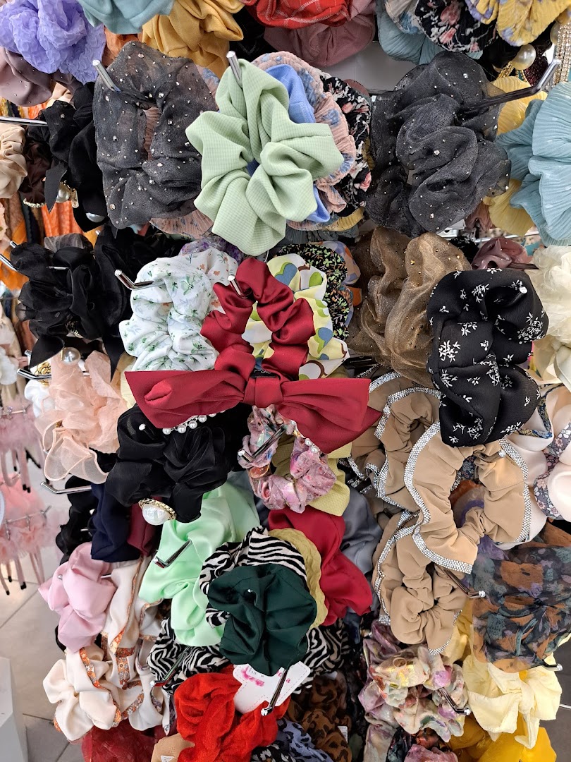 A vibrant display of colorful and textured scrunchies, showcasing a variety of styles and fabrics.