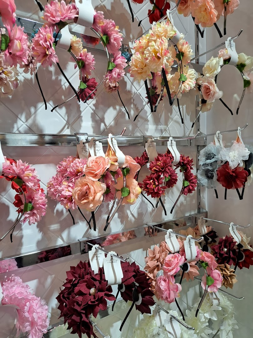 A display of various floral headbands in different colors and styles.