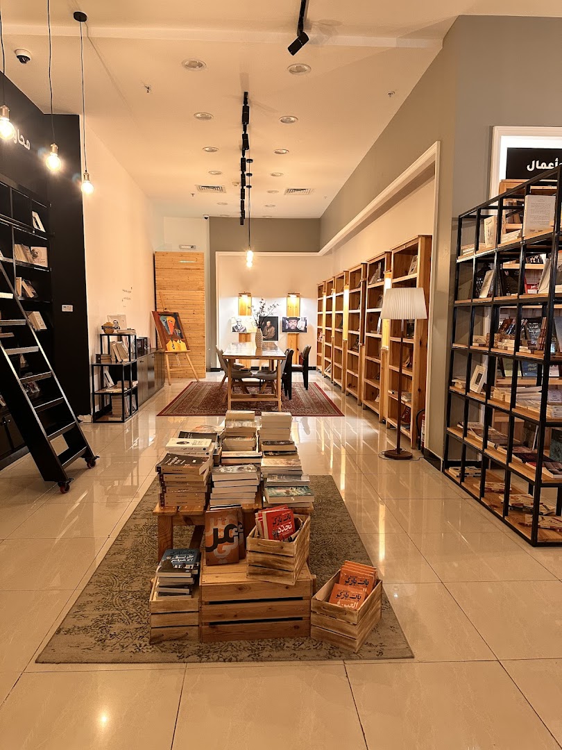 Interior view of a modern bookstore with shelves full of books and a reading area.