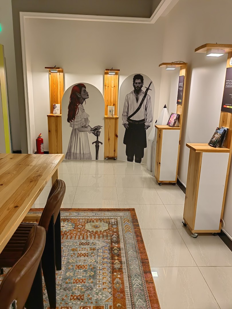 Interior of a shop with fantasy-themed cutouts, display shelves, and seating.
