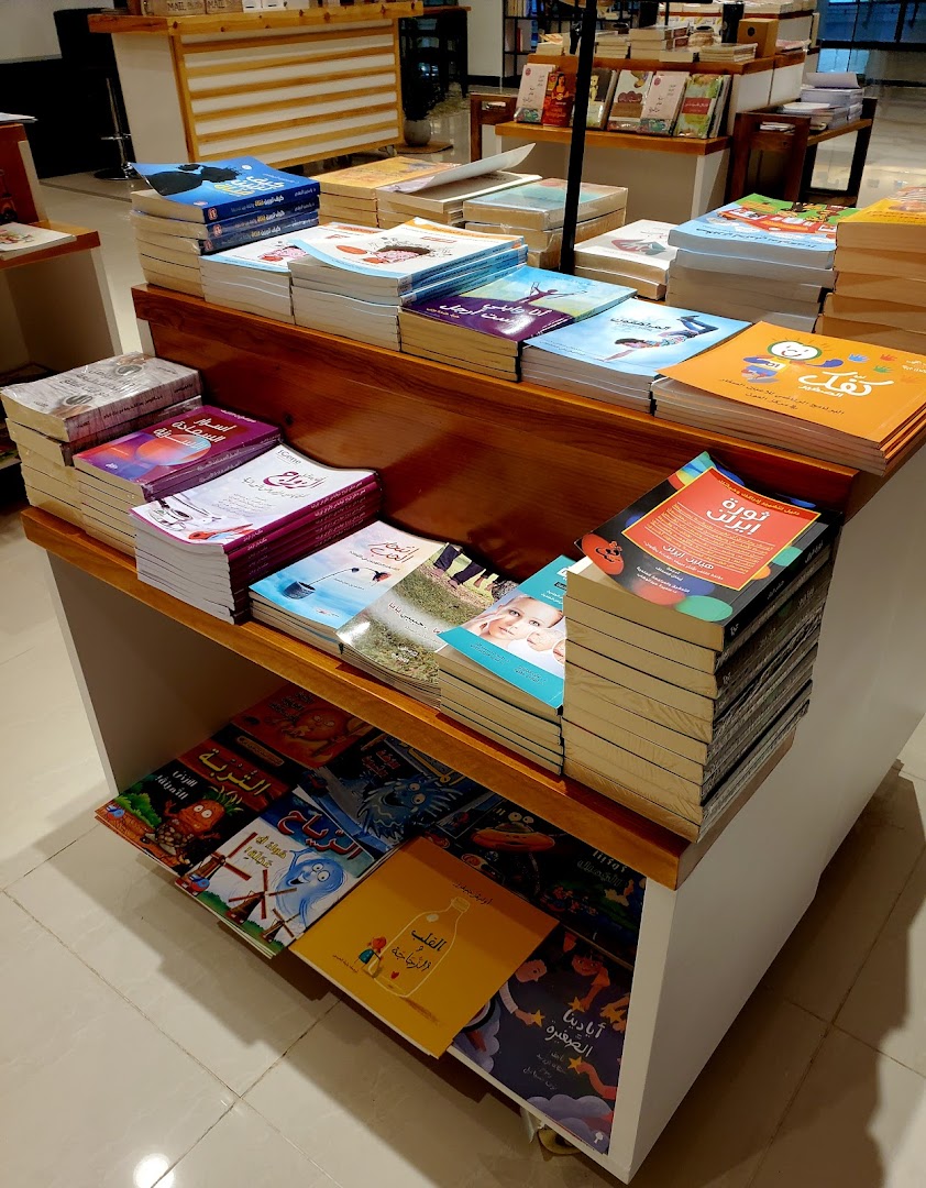 A display of various books, including children's books and novels, neatly arranged on shelves.