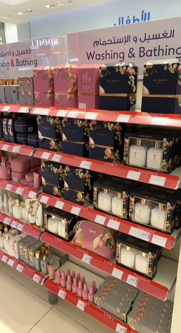 Shelves stocked with Ted Baker gift sets and other beauty products, with 'Washing & Bathing' signage.
