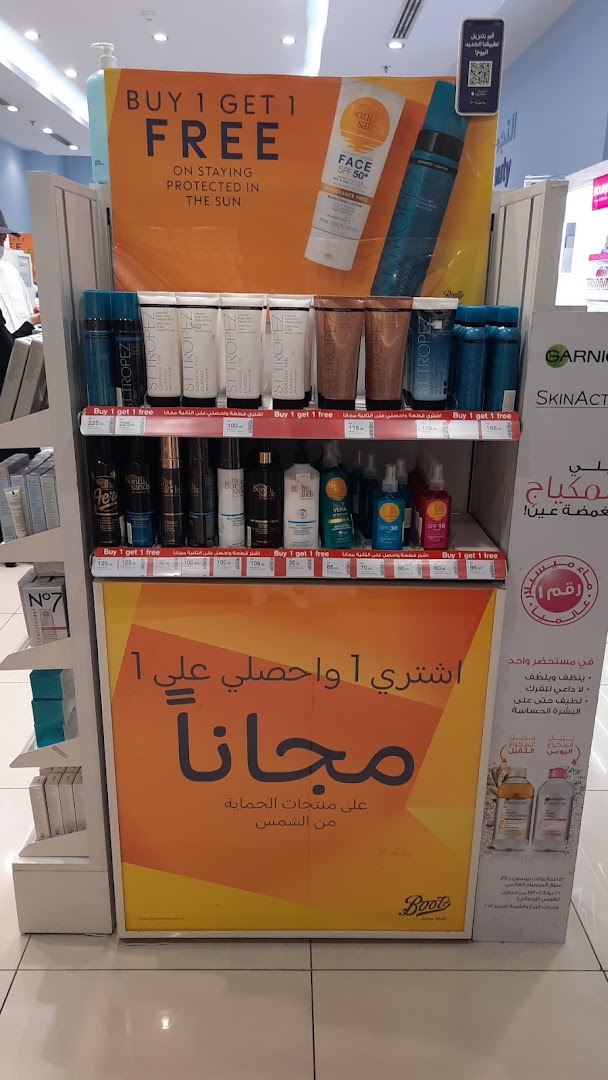 A display of sun protection products with a 'Buy 1 Get 1 Free' offer at Boots.