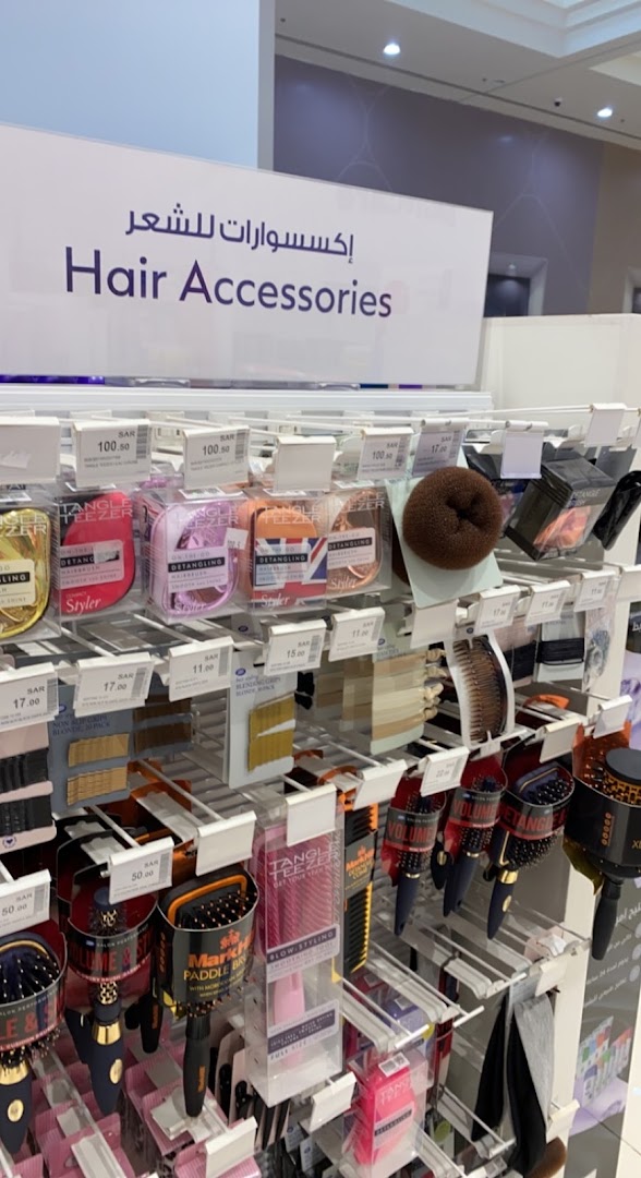 A display of various hair accessories, including brushes, combs, and hair ties, at Boots.